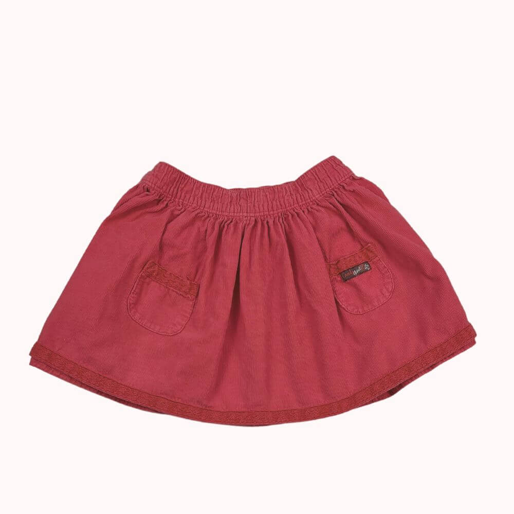 Jupe en velours rose Creeks bébé 12 mois, coupe évasée, poches brodées et taille élastiquée.