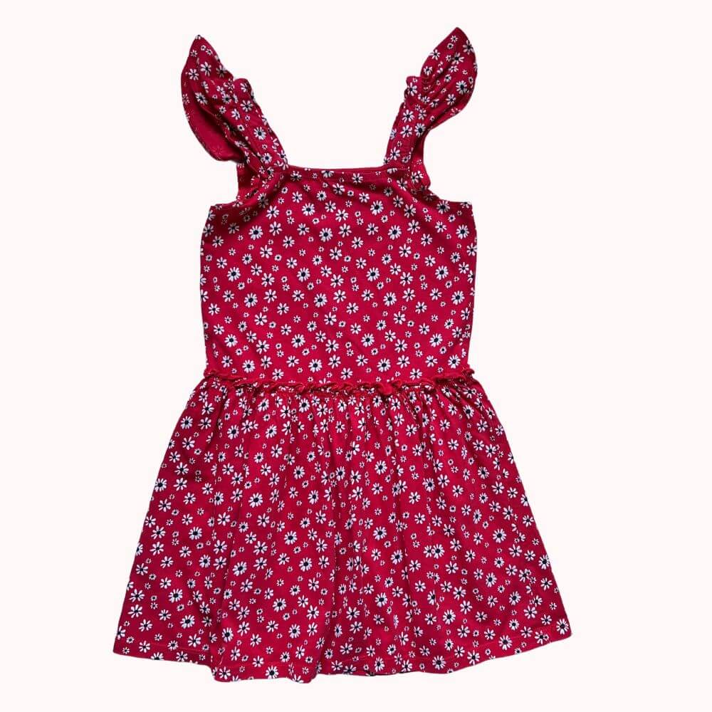 Robe rouge à fleurs blanches pour enfant, avec bretelles volantées et taille élastiquée, coupe fluide et légère.