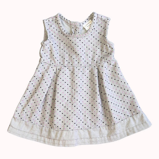 Robe à pois pour enfant, sans manches, avec coupe évasée et boutons dans le dos, en très bon état.