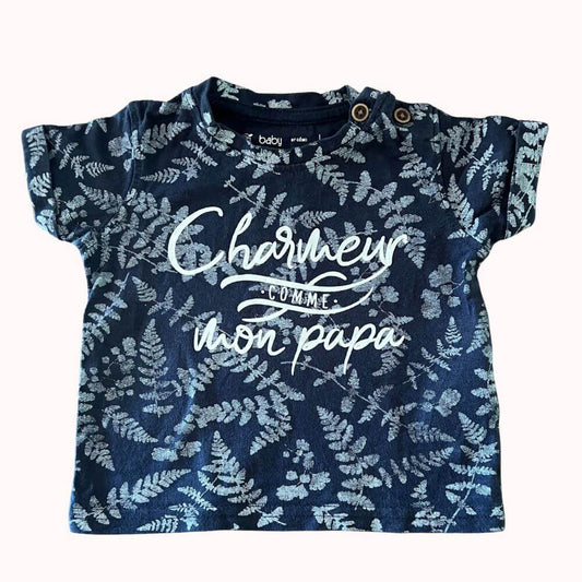 Tee-shirt bébé bleu marine à imprimé feuillage, avec message "Charmeur comme mon papa", boutons-pression à l’épaule, marque Gémo, taille 3 mois.
